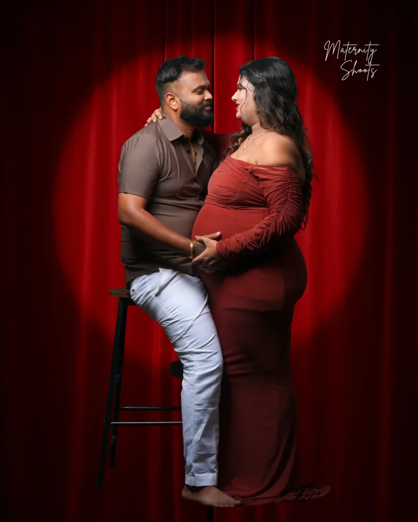 Indoor maternity photoshoot in Jamshedpur with mother wearing purple bodycon in soft studio lighting
