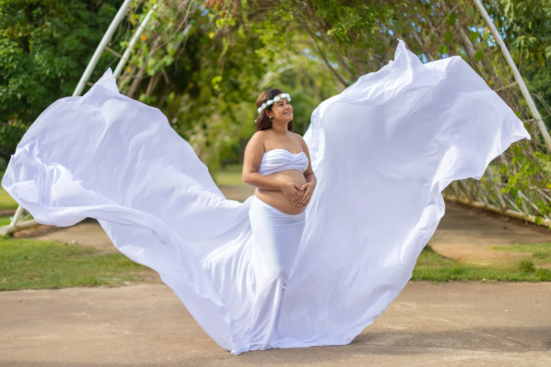 Maternity photoshoot in Jamshedpur with pregnant woman in white gown during outdoor session
