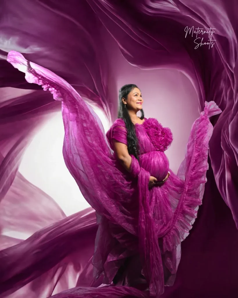 flowing gown pregnancy photoshoot pose with baby bump