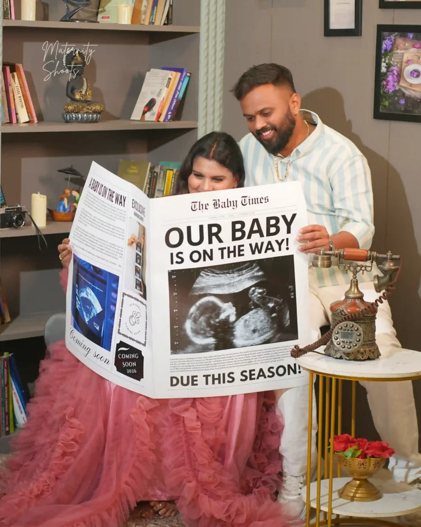 Couple reading baby announcement during indoor maternity photoshoot in Jamshedpur studio