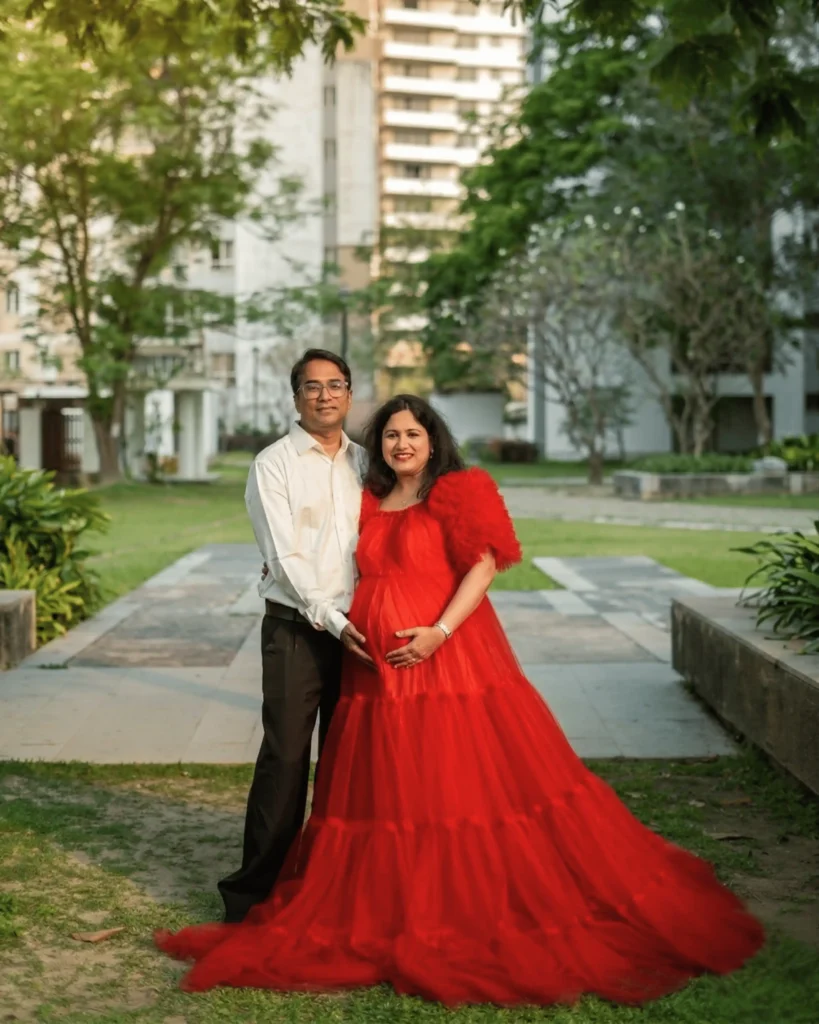 maternity photographer Kolkata couple photoshoot in red gown outdoor location