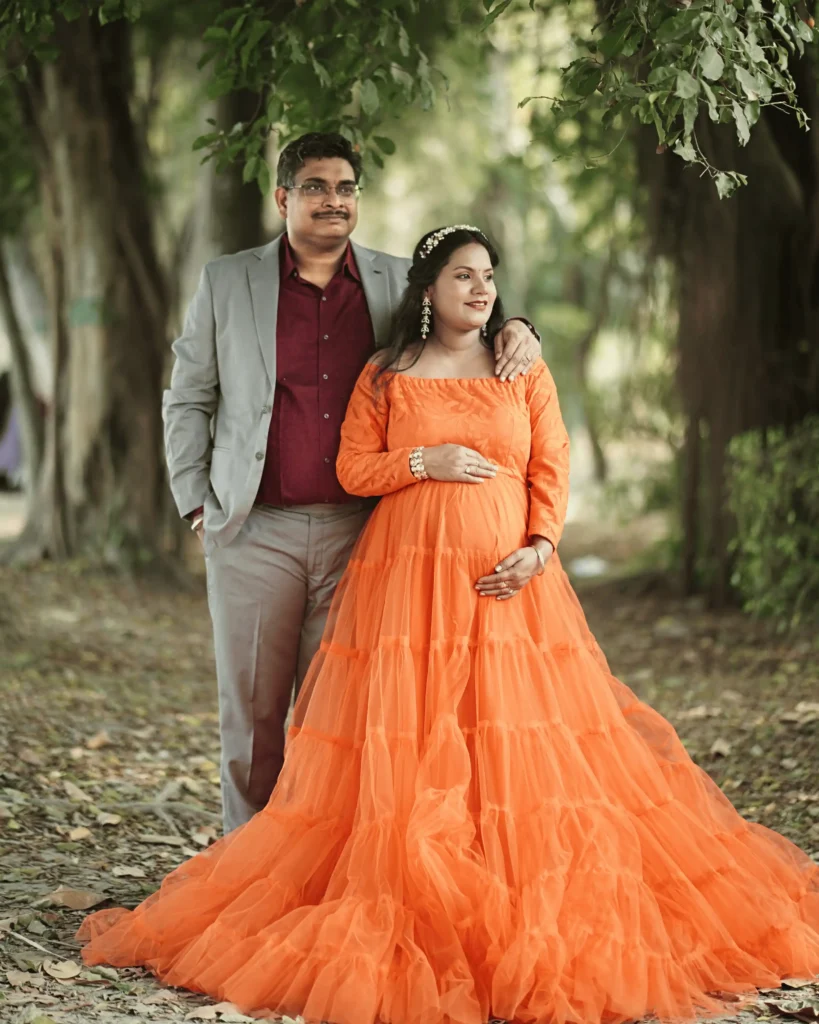 maternity photoshoot in Kolkata with orange gown outdoor cinematic style