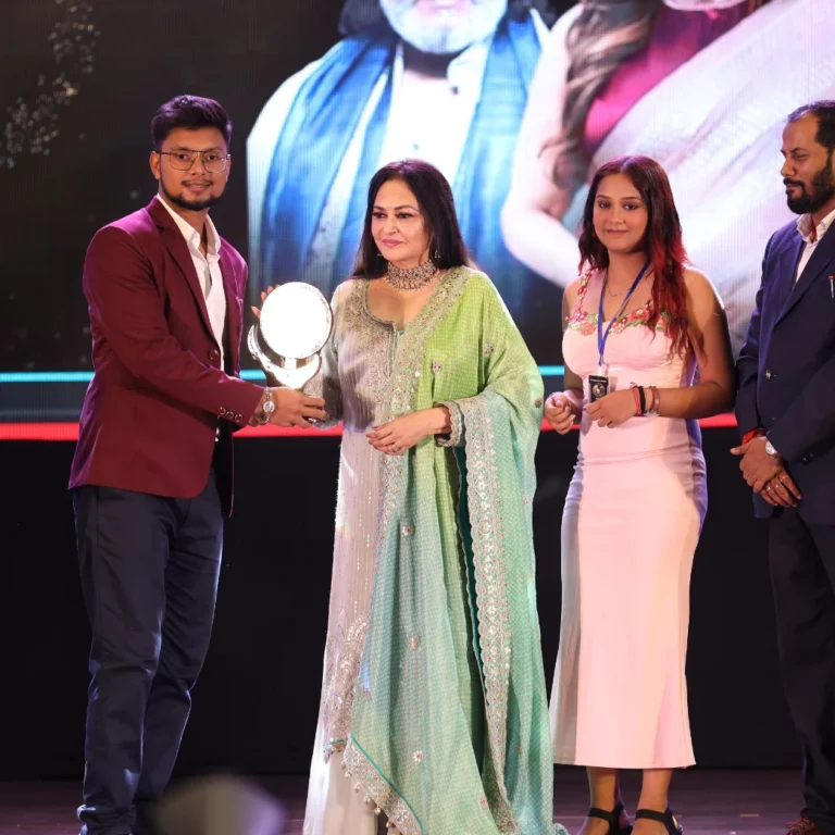 Shivam receiving an award from Jaya Prada alongside dignitaries at an event recognizing Maternity Shoots brand excellence