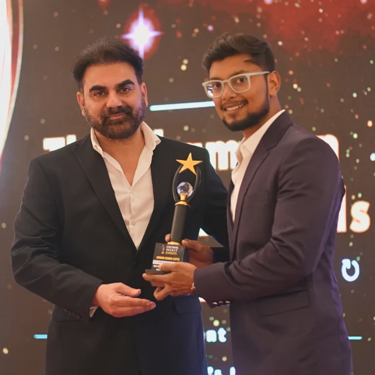 Shivam, co-founder of Maternity Shoots, receiving an award from Arbaaz Khan on stage for excellence in maternity photography services