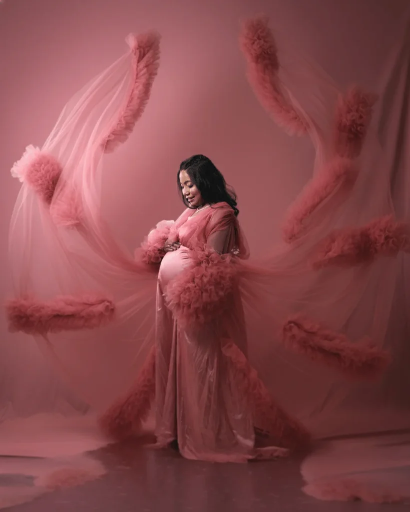 Elegant indoor maternity photoshoot in pink gown at Asansol studio